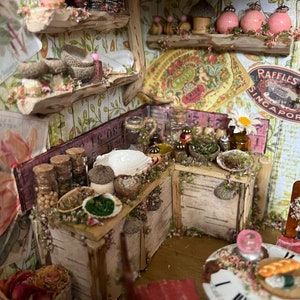 May include: A miniature kitchen with wooden cabinets and shelves, decorated with floral wallpaper and filled with small jars, bowls, and other items. The kitchen is decorated with a vintage floral pattern and a sign that reads "Raffles Singapore".