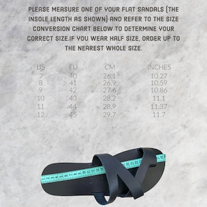 May include: A size chart for flat sandals with measurements in US, EU, centimeters, and inches. The chart shows the insole length of the sandals in each size. The image also shows a close-up of a black leather sandal with a measuring tape.