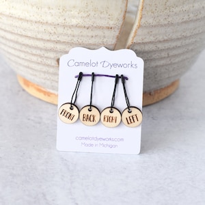 May include: Set of four wooden stitch markers with black string loops. The markers are labeled "Front", "Back", "Right", and "Left". The card reads "Camelot DyeWorks" and "Made in Michigan".