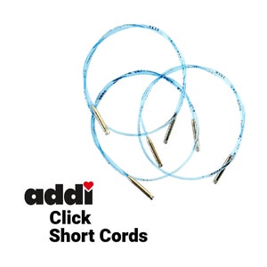 May include: Three blue Addi Click short cords for interchangeable knitting needles. The cords are flexible and have a smooth finish.