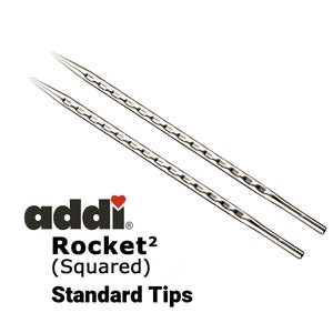 May include: A pair of silver knitting needles with a textured surface. The needles are labeled "addi Rocket² (Squared) Standard Tips".