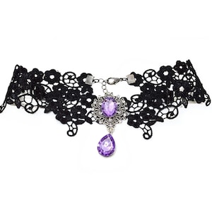 May include: A black lace choker necklace with a silver pendant featuring a large purple gemstone.