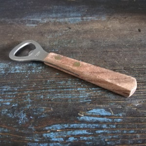 Vintage bottle opener with wooden handle. Kitchen utensils.