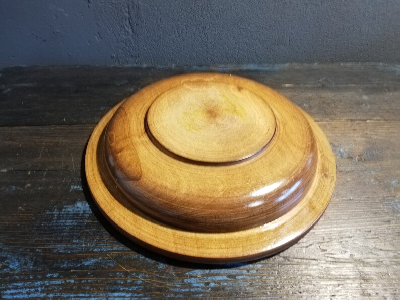 May include: A wooden serving tray with a natural finish. The tray has a raised edge and a smooth surface.