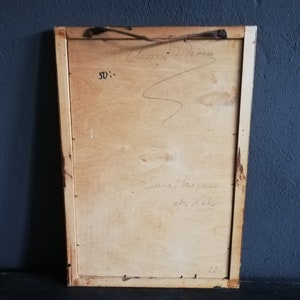 May include: The back of a framed artwork with a wooden frame. The back of the frame is made of wood and has a handwritten inscription that reads "Anna Brown, Sue the gunman, with love, Kathy".