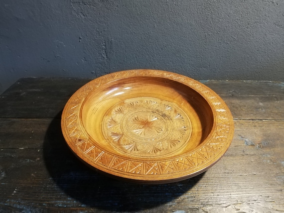 A genuinely hand-carved wooden bowl with organic Scandinavian form — the kind of object that gets passed down, not tossed out.