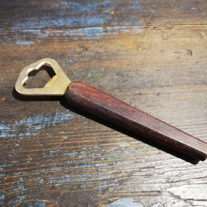 Vintage bottle opener with wooden handle. Kitchen utensils.