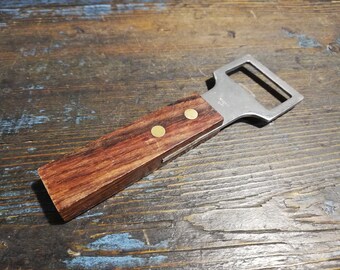 Vintage bottle opener with wooden handle. Kitchen utensils.