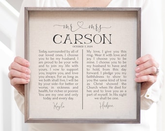 May include: A framed wedding vow print with a beige background and black text. The text reads "Mr. & Mrs. Carson October 7, 2024" and includes vows from the bride and groom.