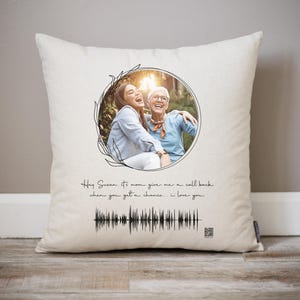 May include: A white throw pillow with a black floral design and a photo of two women smiling. The text "Hey Susan. It's mom give me a call back when you get a chance... i love you" is printed on the pillow.
