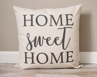 May include: A white throw pillow with black text that reads "HOME sweet HOME".