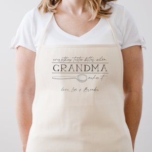 May include: A white apron with the text "everything tastes better when GRANDMA makes it" and a drawing of a spoon. The text "love, Lexi & Brandon" is below the spoon.