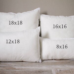 May include: Four white pillow inserts of different sizes. The largest pillow is 18x18 inches, the next largest is 16x16 inches, the next is 12x18 inches, and the smallest is 8x16 inches.