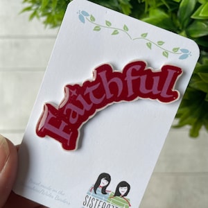 May include: Red enamel pin with the word "Faithful" in a cursive font. The pin is on a white card with the text "Hand made on the Hampshire/Wales Borders" and a logo for "Sisteract212".