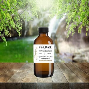 May include: A 4 ounce bottle of Pine, Black 100% Pure Essential Oil. The bottle is amber glass with a black label. The label says "Caliber Products for Life" and "Pine, Black 100% Pure Essential Oil 4 oz 118.3 ml Ingredients: Pine, Black (Pinus nigra) essential oil CaliberForLife.com"