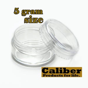 May include: A clear plastic jar with a lid. The jar is labeled "5 gram size".