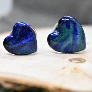 May include: Three heart-shaped glass plugs in different sizes, with blue and green marbled patterns.