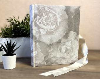 Vintage-style photo album with a light gray peony design cover