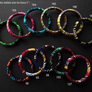 Peut inclure: Un ensemble de bracelets en tissu colorés avec différents motifs. Les bracelets sont numérotés avec les numéros 164, 185, 186, 165, 166, 58, 65, 153, 56, 127 et 161.