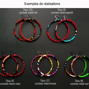 May include: Six pairs of large hoop earrings made with colorful fabric and metal hooks. The earrings are displayed on a black background. The fabric patterns are red, black, white, blue, green, and yellow. The metal hooks are black, silver, and bronze.