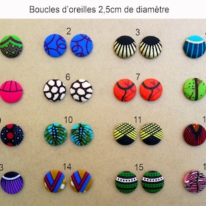May include: Sixteen pairs of colorful fabric earrings, each pair is 2.5 inches in diameter. The earrings are arranged in four rows of four pairs. Each pair has a unique pattern.