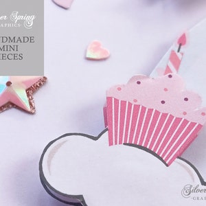 May include: A pink and white cupcake with pink frosting and white sprinkles, topped with a pink and white striped candle. The cupcake is on a white background with a pink star and a pink heart.