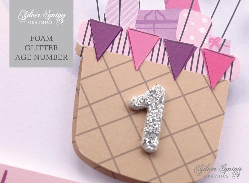 May include: A brown and white checkered paper craft with a silver glitter number one. The craft is decorated with purple, pink, and white paper flags.