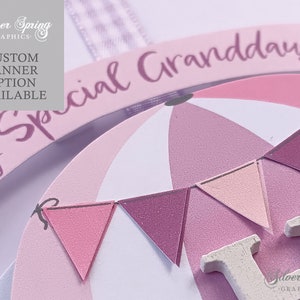 May include: A pink and white wooden sign with the text "Special Granddaughter" and a hot air balloon design. The balloon has pink and white stripes and a pink and white bunting.
