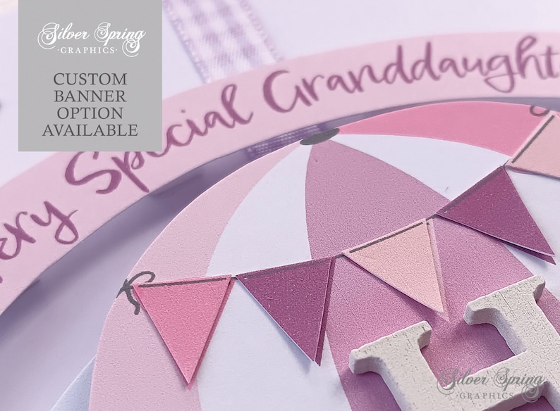 May include: A pink and white wooden sign with the text "Special Granddaughter" and a hot air balloon design. The balloon has pink and white stripes and a pink and white bunting.