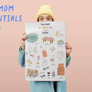 May include: A woman wearing a yellow beanie holds a poster with a list of dog essentials. The poster is titled "Dog Mom Essentials - goods guide" and features illustrations of dog beds, collars, leashes, toys, and other items.