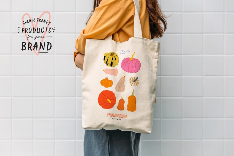 May include: A white canvas tote bag with a colorful illustration of pumpkins and gourds. The text "It's the most... PUMPKIN season of all" is printed on the bag.