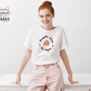 May include: White t-shirt with the text "Pumpkin season has begun" and a graphic of three pumpkins.