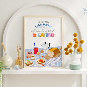 May include: A colorful kitchen print with the text "The only thing I like better than taking about food is eating". The print features a breakfast scene with a loaf of bread, a coffee pot, a bowl of fruit, and a plate of eggs.