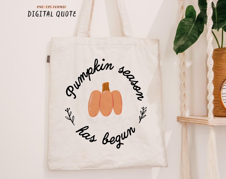 May include: A white tote bag with the text "Pumpkin season has begun" in black cursive font. A small orange pumpkin illustration is centered on the bag.