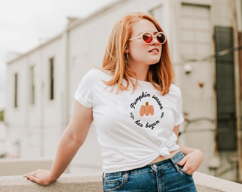 May include: A white t-shirt with the text "Pumpkin season has begun" and a small illustration of a pumpkin.