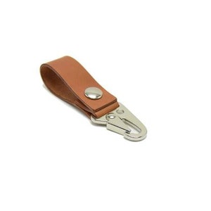 May include: A brown leather key chain with a silver metal clip.