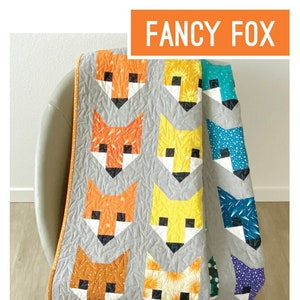 May include: A quilt pattern for making fox-shaped quilts. The pattern is called "Fancy Fox" and is by Elizabeth Hartman. The quilt is made with a variety of colorful fabrics, including orange, yellow, blue, and purple.