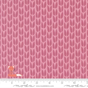 May include: A pink fabric featuring a repeating pattern of vertical, stylized knit stitch shapes in a darker shade of pink. A small orange fox icon is visible in the bottom left corner, and a ruler is printed along the bottom edge.