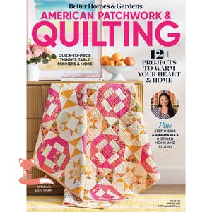 May include: The cover of "American Patchwork & Quilting" magazine features a colorful quilt draped over a wooden cabinet. The quilt has pink, yellow, and white geometric patterns. The magazine cover also displays text about quick-to-piece throws and projects to warm your heart.
