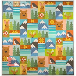 May include: A patchwork quilt with a forest theme, featuring squares with bears, rabbits, birds, mountains, trees, mushrooms, and suns. The word "Preorder" is at the top. The quilt is in shades of blue, orange, green, and brown. A decorative item for a nursery.
