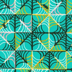 May include: A teal background with a repeating pattern of black and white spiderwebs with gold accents. The spiderwebs are arranged in a geometric pattern.