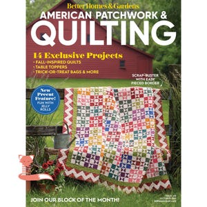 May include: The cover of "American Patchwork & Quilting" magazine displays a vibrant quilt over a wooden fence. The magazine cover includes text about fall-inspired quilts, table toppers, and trick-or-treat bags. A red barn is in the background.