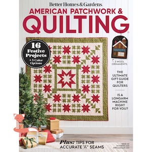 May include: The cover of American Patchwork & Quilting magazine displays a quilt with red star patterns on a cream background. The magazine cover includes text about festive projects, gift guides, and quilting tips.