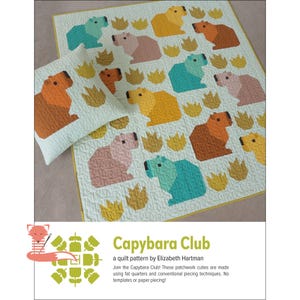 May include: A light green quilt and pillow set featuring a repeating pattern of colorful capybara figures and stylized grass. The capybaras are in shades of orange, yellow, pink, and teal. The text "Capybara Club" is visible.