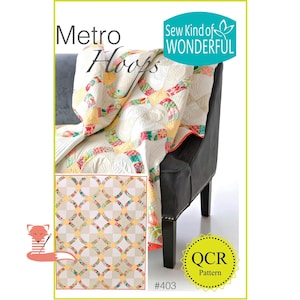 May include: A colorful quilt with a circular pattern is draped over a black armchair. The quilt features a cream background with intersecting circles in various colors. The words "Metro Hoops" and "Sew Kind of Wonderful" are visible.