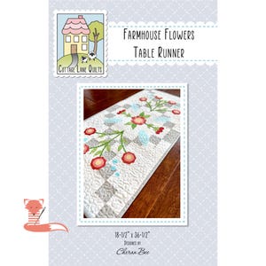 May include: A quilted table runner with a floral design. The runner features red and pink flowers with green stems and blue accents on a white and gray checkered background. The dimensions are 18.5 x 36.5 inches. The text "Farmhouse Flowers Table Runner" is displayed.