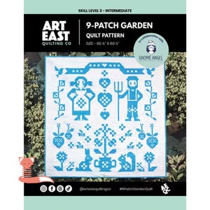 May include: A white and blue quilt pattern with the text "9-Patch Garden" and "Art East Quilting Co." The quilt features a folk art design with figures, hearts, and floral elements. The quilt measures 60 x 60 inches.
