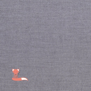 May include: A gray fabric background with a small orange fox wearing a striped scarf.