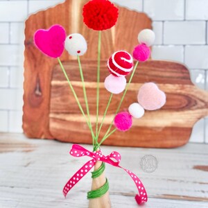 Valentines Day felt bouquet. felt spray comes as shown attached to the wooden cone with ribbon about 10 inches tall but varies / handmade