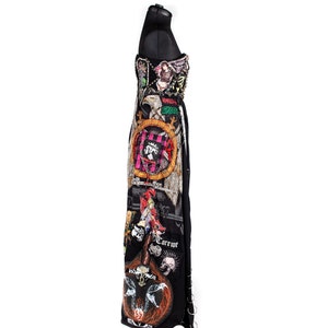 May include: A black maxi dress with a variety of colorful patches and embellishments. The patches feature images of skulls, eagles, and other graphic designs. The dress has a fitted bodice and a flowing skirt.